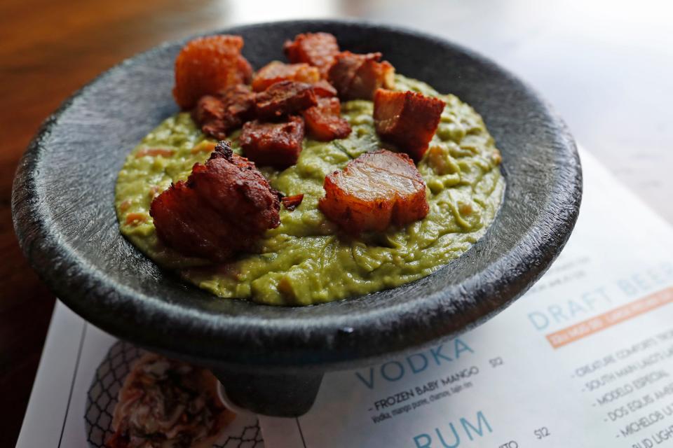 Guacamole with pork belly on top at San Angel Cocina & Cantina on Broad Street in Athens, Ga., on Wednesday, May 15, 2024.
