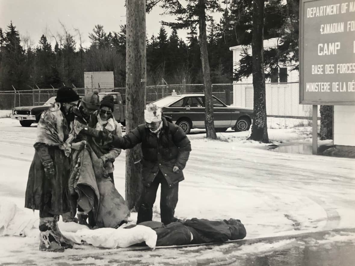 A group of women, posing as victims of nuclear war, protest outside of Camp Debert on Feb. 29, 1984.  (Ken Burke - image credit)