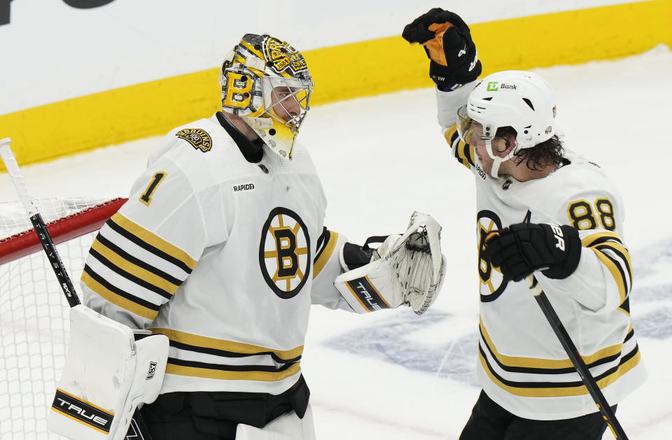 Boston Bruins goaltender Jeremy Swayman (1) and David Pastrnak (88) celebrate after defeating the Toronto Maple Leafs in Game 3 of an NHL hockey Stanley Cup first-round playoff series in Toronto on Wednesday, April 24, 2024. (Frank Gunn/The Canadian Press via AP)
