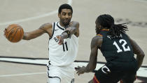 Brooklyn Nets' Kyrie Irving (11) drives past Cleveland Cavaliers' Taurean Prince (12) during double overtime of an NBA basketball game, Wednesday, Jan. 20, 2021, in Cleveland. The Cavaliers won 147-135 in double-overtime. (AP Photo/Tony Dejak)