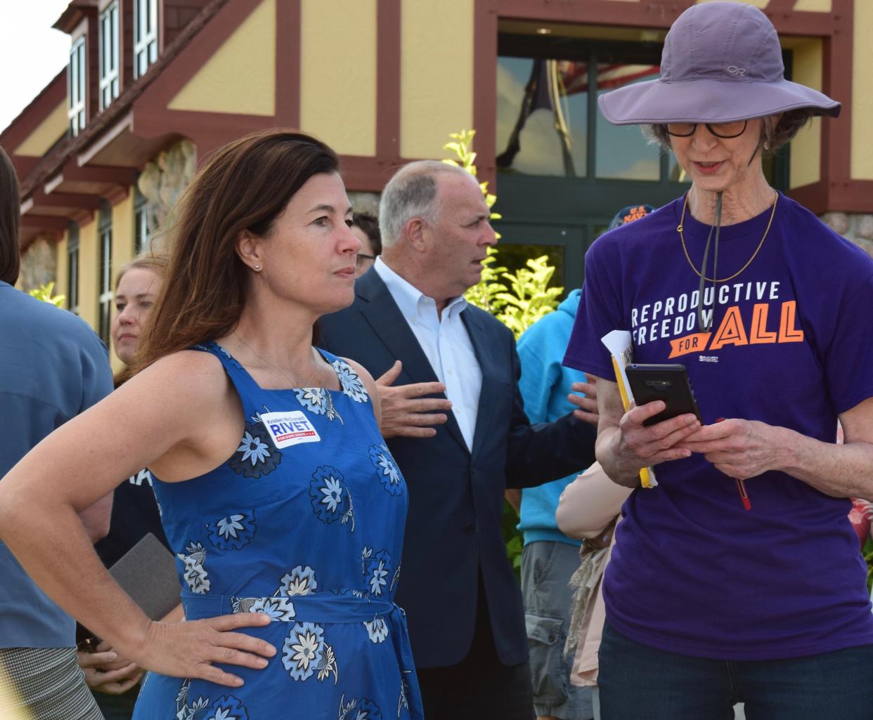 Kristen McDonald Rivet, left, Democratic candidate for Michigan Senate, District 35, speaks with an organizer at a reproductive rights rally in Midland, Michigan, on June 27, 2022.