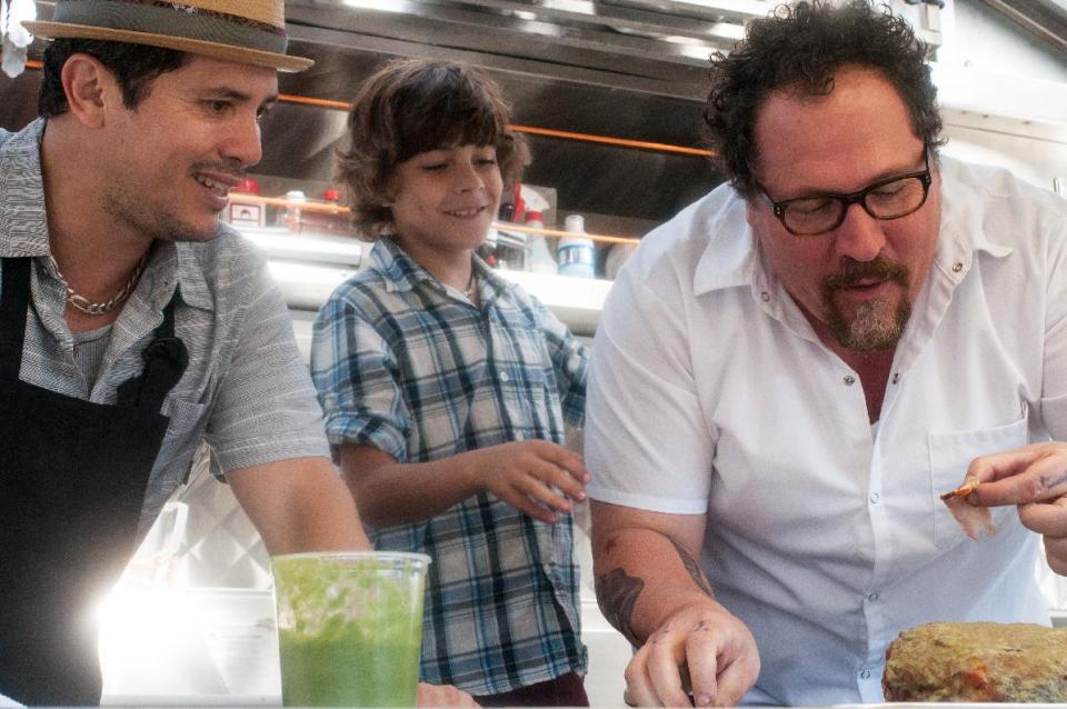 This image released by Open Road Films shows John Leguizamo, from left, Emjay Anthony and Jon Favreau in a scene from "Chef." (AP Photo/Open Road Films, Merrick Morton)