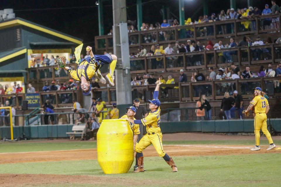 Savannah Bananas pitcher Mat Wolf back flips off a rodeo barrel during Banana Fest on Saturday February 25, 2023 at Historic Grayson Stadium in Savannah, Georgia. The popular baseball team's 2023 tour includes games in Oklahoma City and Tulsa.