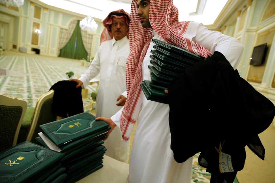 <p>Aides collect folders signifying signed agreements between the Saudi government and U.S. companies after a signing ceremony with Saudi Arabia’s King Salman bin Abdulaziz Al Saud and President Donald Trump at the Royal Court in Riyadh, Saudi Arabia on May 20, 2017. (Photo: Jonathan Ernst/Reuters) </p>