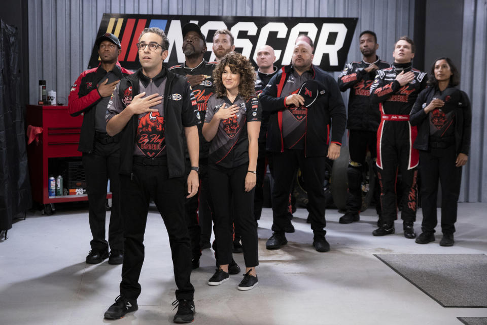 This image released by Netflix shows Dan Ahdoot, foreground, Kevin James, fourth from right and Freddie Stroma, second right, in a scene from the comedy series "The Crew." (Eric Liebowitz/Netflix via AP)