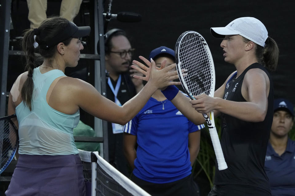 Iga Swiatek, of Poland, right, is congratulated by Jessica Pegula, of the United States, in her victory in the women's singles final of the WTA Finals tennis championships, in Cancun, Mexico, Monday, Nov. 6, 2023. (AP Photo/Fernando Llano)