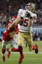 FILE - In this Feb. 2, 2020, file photo, San Francisco 49ers' George Kittle (85) catches a pass in front of Kansas City Chiefs' Daniel Sorensen during the first half of the NFL Super Bowl 54 football game in Miami Gardens, Fla. The play was called back on a penalty by Kittle. Kittle has agreed to a five-year extension with the San Francisco 49ers that reportedly is the richest contract ever at the position. A person familiar with the deal says the sides agreed Thursday, Aug. 13, 2020, on the deal to keep Kittle off the market next offseason. (AP Photo/Mark Humphrey, File)