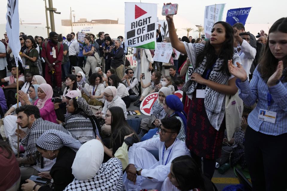 Activists demonstrate for climate justice and a ceasefire in the Israel-Hamas war at the COP28 U.N. Climate Summit, Saturday, Dec. 9, 2023, in Dubai, United Arab Emirates. (AP Photo/Peter Dejong)