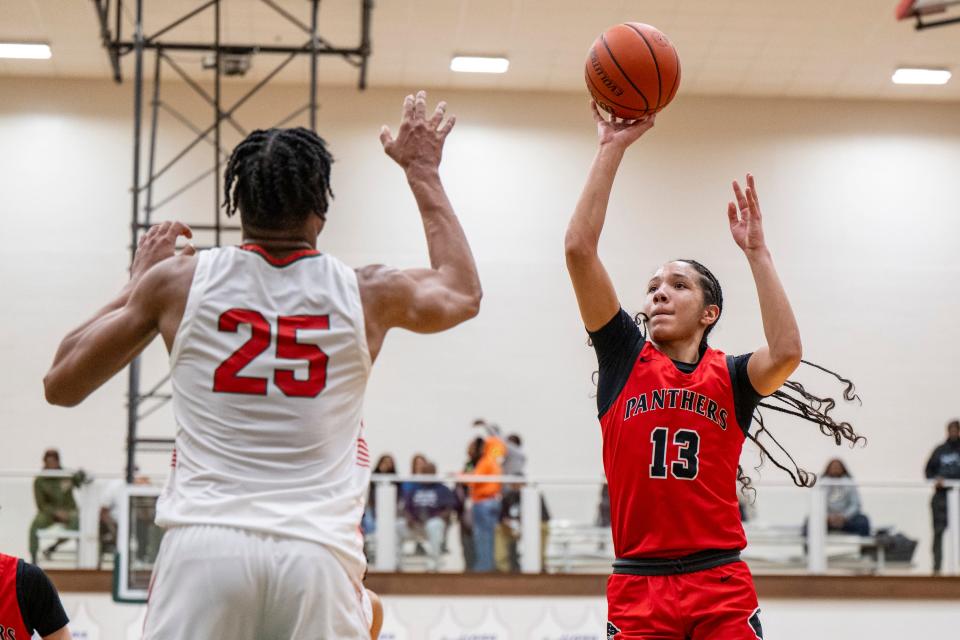 North Central High School junior Papi Rivera (13) shoots over Lawrence North High School sophomore Kai McGrew (25) during the first half of an IHSAA Class 4A Boys’ Sectional basketball game, Wednesday, Feb. 28, 2024, at Lawrence North High School.