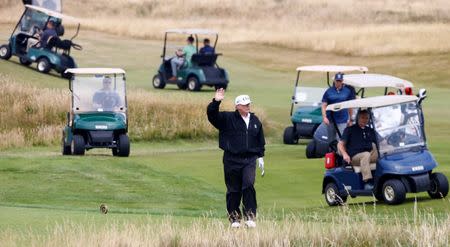 U.S. President Donald Trump gestures as he walks on the course of his golf resort, in Turnberry, Scotland July 14, 2018. REUTERS/Henry Nicholls