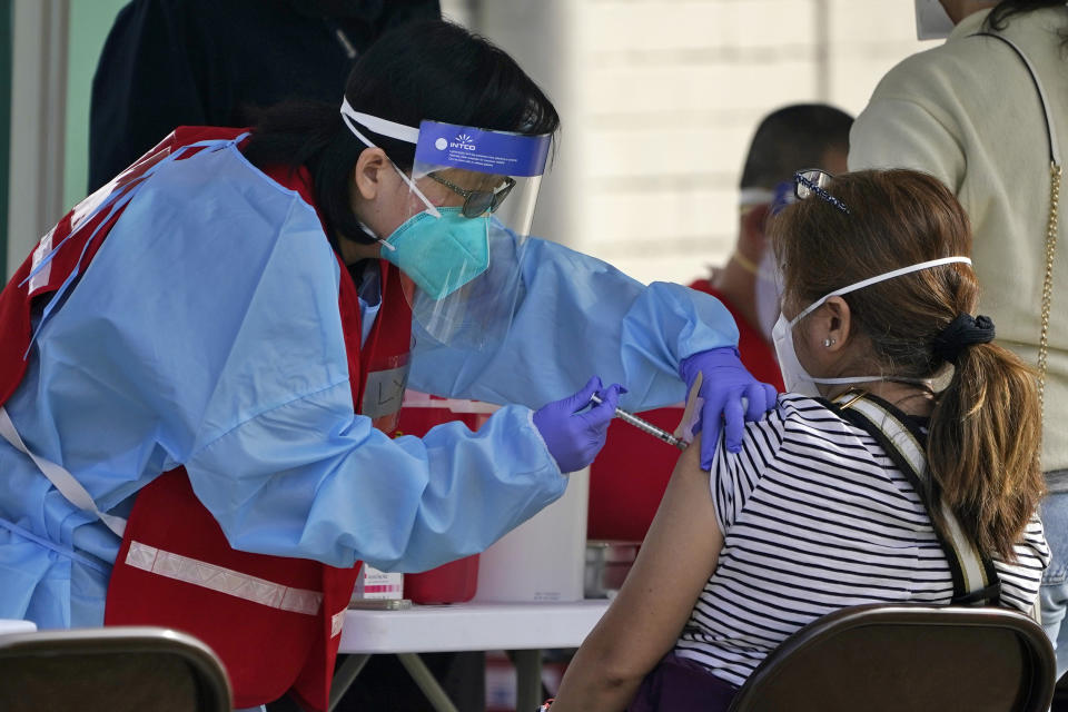 A COVID-19 vaccine is administered at a site for health care workers at Ritchie Valens Recreation Center Wednesday, Jan. 13, 2021, in Pacoima, Calif. (AP Photo/Marcio Jose Sanchez)