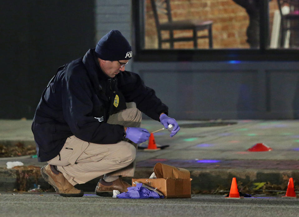 FILE - A Huntington police officer investigates the scene of a shooting at a bar in Huntington, W.Va. on, Jan. 1, 2020. Kymoni Davis was sentenced Monday, Dec. 19, 2022, to eight years in prison for being a felon in possession of a firearm stemming from the shooting on New Year’s Eve 2019. Prosecutors said Davis had been thrown out of the bar prior to the shooting that wounded seven people. (Lori Wolfe/The Herald-Dispatch via AP, File)