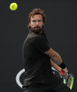 Latvia's Ernests Gulbis makes a backhand return to Slovenia's Aljaz Bedene during their second round singles match at the Australian Open tennis championship in Melbourne, Australia, Thursday, Jan. 23, 2020. (AP Photo/Andy Wong)