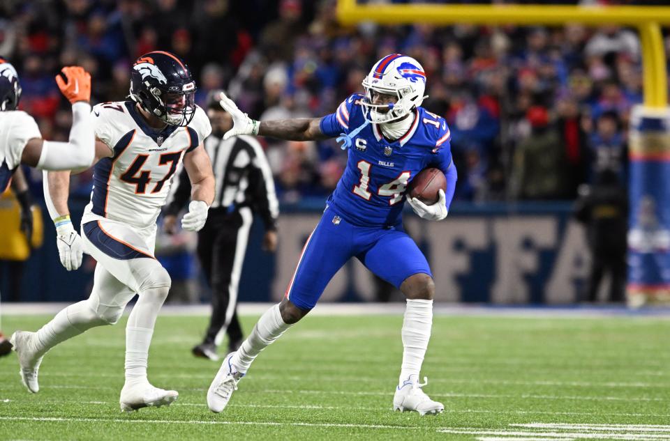 Buffalo Bills wide receiver Stefon Diggs (14) tries to avoid a tackle by Denver Broncos linebacker Josey Jewell.