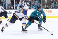 May 19, 2019; San Jose, CA, USA; St. Louis Blues defenseman Alex Pietrangelo (27) and San Jose Sharks center Joe Pavelski (8) reach for the puck during the first period in Game 5 of the Western Conference Final of the 2019 Stanley Cup Playoffs at SAP Center at San Jose. Mandatory Credit: Darren Yamashita-USA TODAY Sports