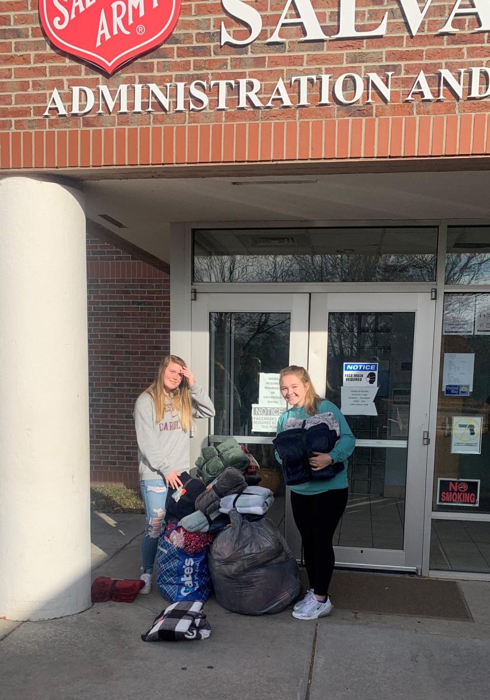 Bessemer City High School seniors and Pep Club members Riley Royer and Lacey Pettry deliver blankets in December 2021 to the Salvation Army shelter in Gastonia. They collected the blankets with the help of Gaston County Police Officer Jeff Thompson.