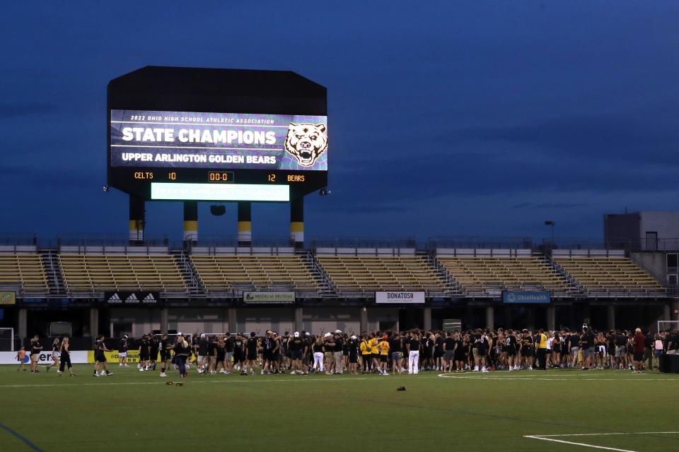 Upper Arlington players, coaches, family and students mingle on the field following a 12-10 win over Dublin Jerome in the boys lacrosse state championship game June 4.