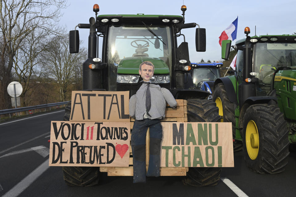 An effigy of French President Emmanuel Macron is seen on a tractor as farmers demonstrate on a highway near Paris's main airport, Monday, Jan. 29, 2024 near Roissy-en-France, north of Paris. Protesting farmers vowed to encircle Paris with tractor barricades and drive-slows on Monday, aiming to lay siege to France's seat of power in a battle with the government over the future of their industry, which has been shaken by repercussions of the Ukraine war. (AP Photo/Matthieu Mirville)