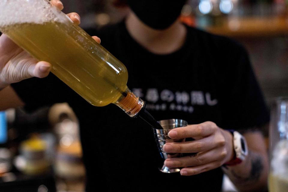 a bartender pouring a shot