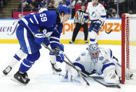 Tampa Bay Lightning goaltender Andrei Vasilevskiy (88) makes a save against Toronto Maple Leafs' Tyler Bertuzzi (59) during the second period of an NHL hockey game Wednesday, April 3, 2024, in Toronto. (Chris Young/The Canadian Press via AP)