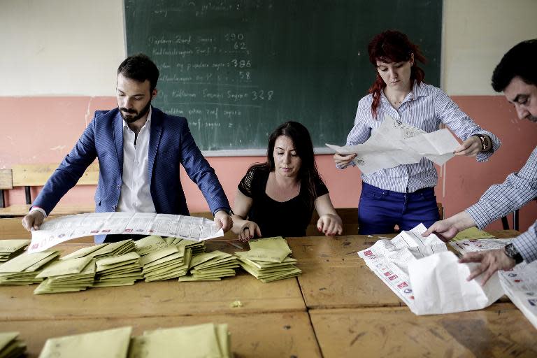 Turkish election officials count ballots in a school in Istanbul after the polls closed on June 7, 2015, during the nationwide legislative election