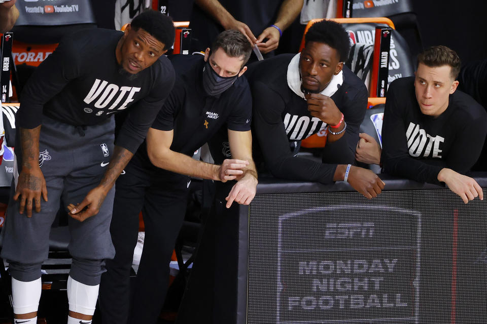 LAKE BUENA VISTA, FLORIDA - OCTOBER 02: Goran Dragic #7 and Bam Adebayo #13 of the Miami Heat look on from the bench during Game Two of the 2020 NBA Finals against the Los Angeles Lakers at AdventHealth Arena at ESPN Wide World Of Sports Complex on October 02, 2020 in Lake Buena Vista, Florida. NOTE TO USER: User expressly acknowledges and agrees that, by downloading and or using this photograph, User is consenting to the terms and conditions of the Getty Images License Agreement. (Photo by Kevin C. Cox/Getty Images)