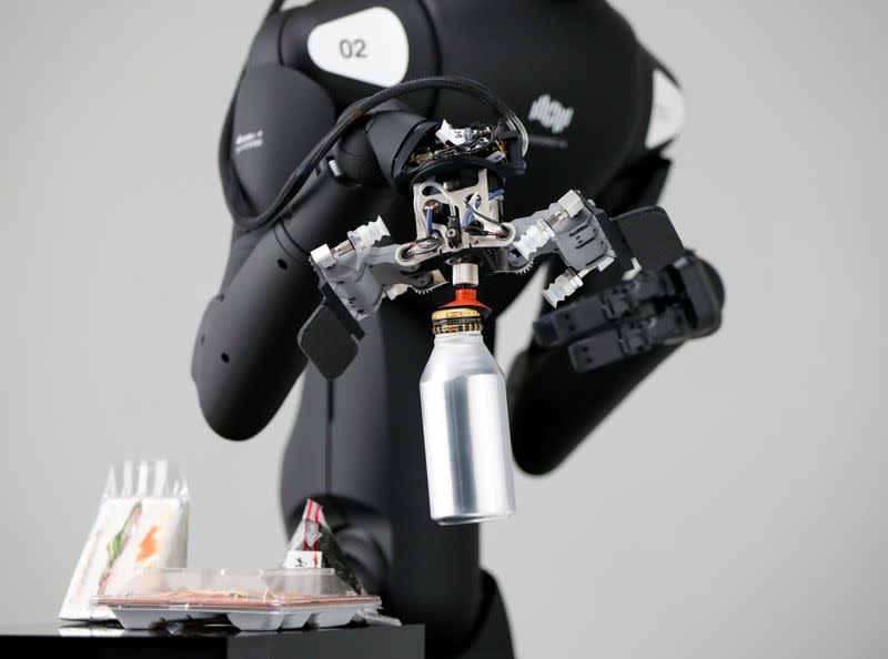 Telexistence's shelf-stacking avatar robot, designed to resemble a kangaroo and developed to work in a convenience store, is demonstrated during a photo opportunity ahead of its unveiling in Tokyo, Japan