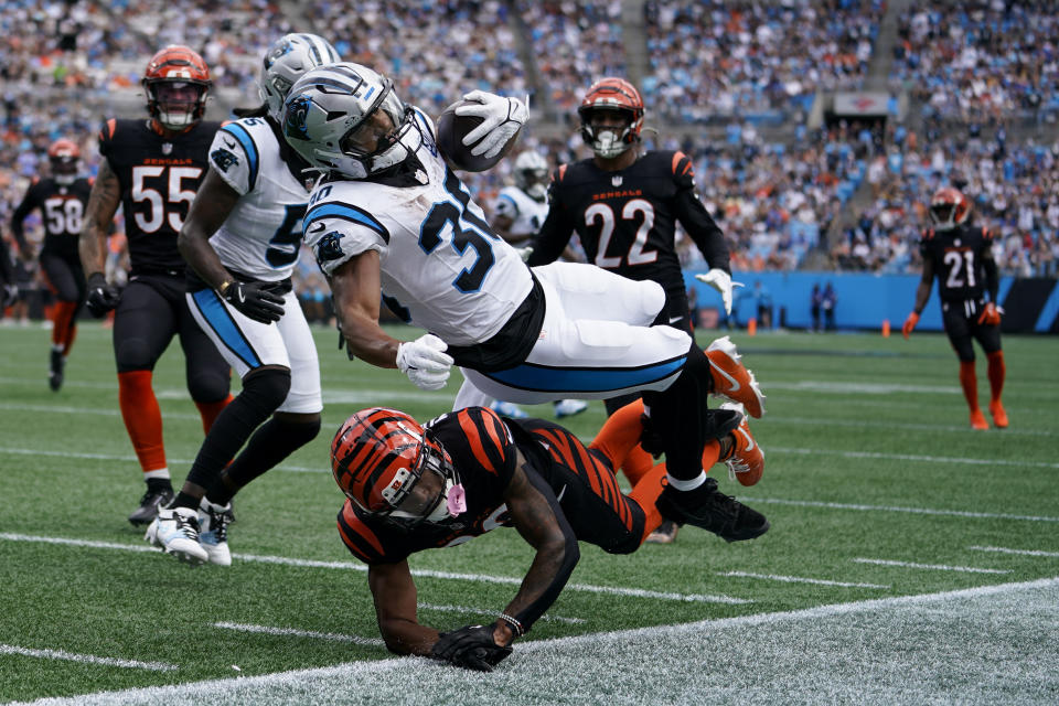 Carolina Panthers running back Chuba Hubbard is tackled by Cincinnati Bengals cornerback DJ Turner II during the first half of an NFL football game, Sunday, Sept. 29, 2024, in Charlotte, N.C. (AP Photo/Erik Verduzco)