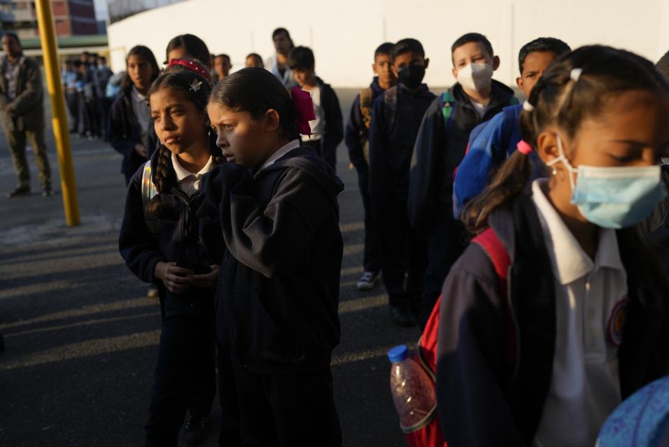 Children line up to enter their classrooms in Caracas, Venezuela, Monday, Feb. 27, 2023. A generation of children in Venezuela have only known a country in crisis, plagued over the last decade or more by shortages and inflation. (AP Photo/Ariana Cubillos)ore by shortages and inflation. (AP Photo/Ariana Cubillos)