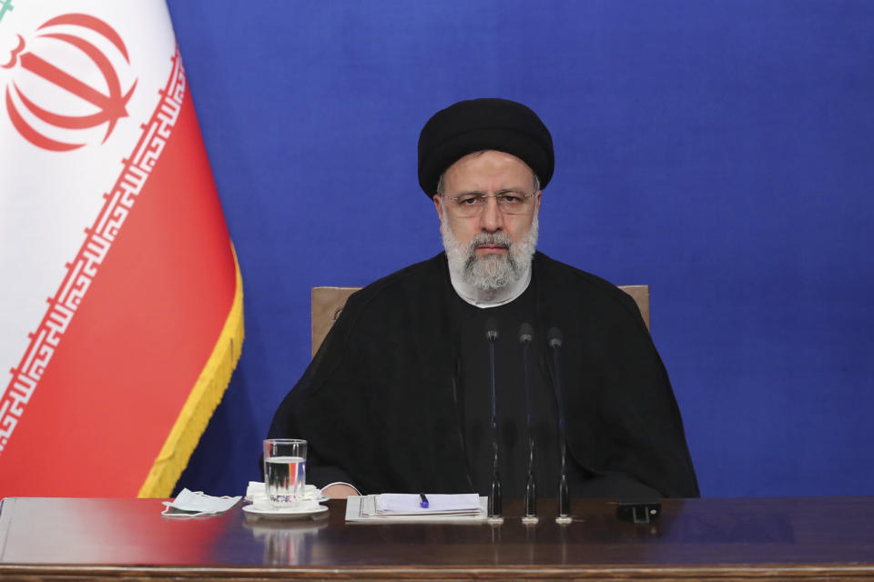 In this photo released by the official website of the office of the Iranian Presidency, President Ebrahim Raisi sits during his press conference in Tehran, Iran, Monday, Aug. 29, 2022. Raisi warned that any roadmap to restore Tehran's tattered nuclear deal with world powers must see international inspectors end their probe on man-made uranium particles found at undeclared sites in the country. (Iranian Presidency Office via AP)