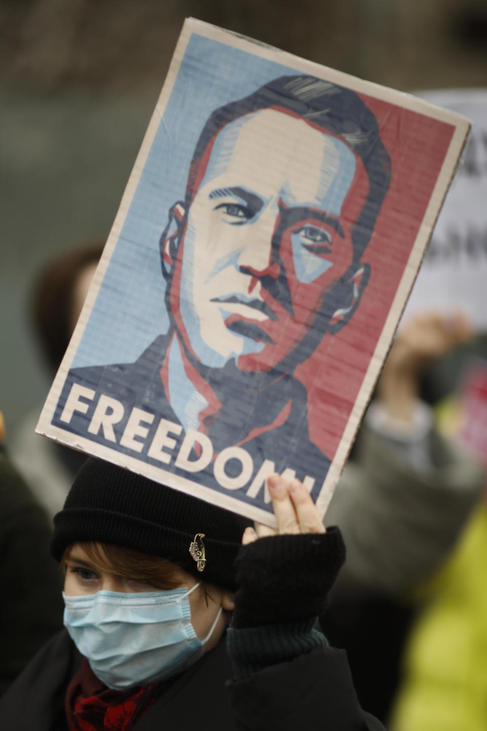 A woman shows poster with a drawing of Russian opposition leader Alexei Navalny, as she attends a protest against the jailing of the Russian opposition leader in front of the chancellery in Berlin, Germany, Saturday, Jan. 23, 2021. A Russian judge had ordered opposition leader Alexei Navalny jailed for 30 days, after the leading Kremlin critic returned to Russia from Germany where he was recovering from nerve agent poisoning. (AP Photo/Markus Schreiber)