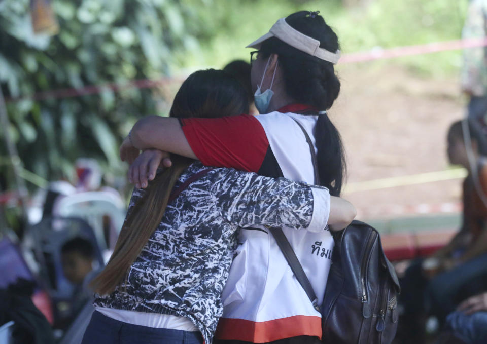 <p>A family member, left, and a Thai official hug each other near a cave where 12 boys and their soccer coach are trapped, in Mae Sai, Chiang Rai province, in northern Thailand, July 5, 2018. (Photo: Sakchai Lalit/AP) </p>