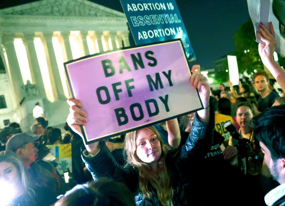 Pro-abortion-rights protester holds poster that reads,"Bans off my body."