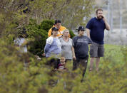 <p>Residents of the apartment complex where Waffle House shooting suspect Travis Reinking lived watch as police work near the wooded area where Reinking was captured Monday, April 23, 2018, in Nashville, Tenn. Police say Reinking shot and killed at least four people at a nearby Waffle House restaurant Sunday. (Photo: Mark Humphrey/AP) </p>