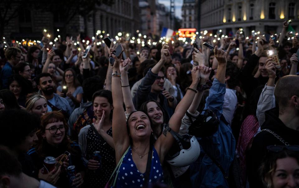 People celebrate during an election night rally