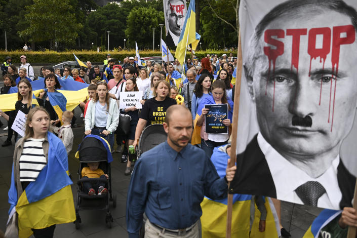 Members of Sydney's Ukraine community hold a candle light vigil to commemorate the one-year anniversary of Russia's invasion of Ukraine, in front of St. Mary's Cathedral in Sydney, Thursday, Feb. 23, 2023. (Dean Lewins/AAP Image via AP)