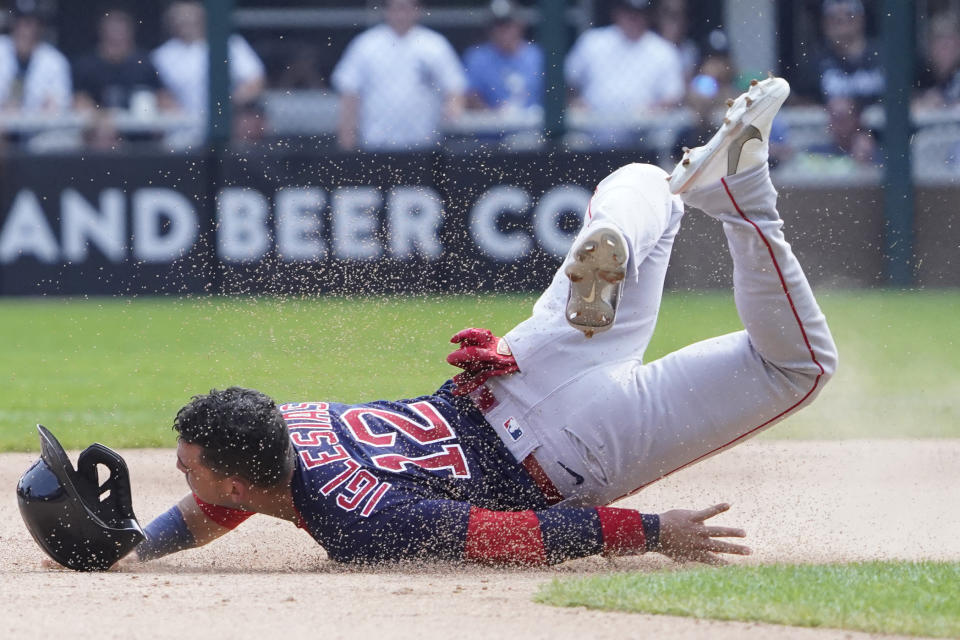Boston Red Sox's Jose Iglesias (12) loses his helmet as he slides into second base against the Chicago White Sox during the sixth inning of a baseball game, Sunday, Sept. 12, 2021, in Chicago. (AP Photo/David Banks)