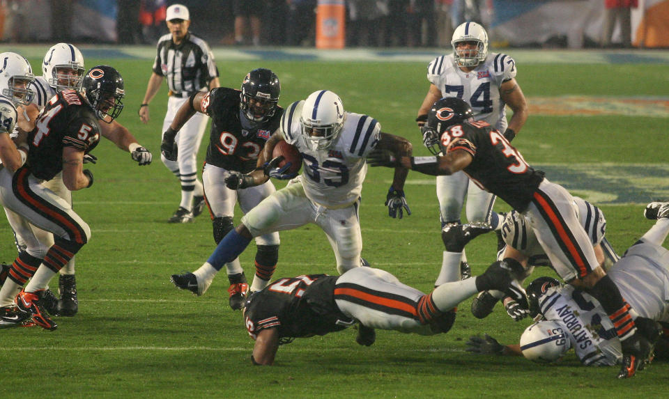 Feb 4, 2007; Miami, FL, USA; Indianapolis Colts running back Dominic Rhodes (33) jumps over Chicago Bears (55) <a class="link " href="https://sports.yahoo.com/nfl/players/6404/" data-i13n="sec:content-canvas;subsec:anchor_text;elm:context_link" data-ylk="slk:Lance Briggs;sec:content-canvas;subsec:anchor_text;elm:context_link;itc:0">Lance Briggs</a> while being hit by <a class="link " href="https://sports.yahoo.com/nfl/players/6371/" data-i13n="sec:content-canvas;subsec:anchor_text;elm:context_link" data-ylk="slk:Charles Tillman;sec:content-canvas;subsec:anchor_text;elm:context_link;itc:0">Charles Tillman</a> (33) in the third quarter of Super Bowl XLI at Dolphins Stadium. The Colts beat the Bears 29-17. Mandatory Credit: Matthew Emmons-USA TODAY Sports Copyright © 2007 Matthew Emmons