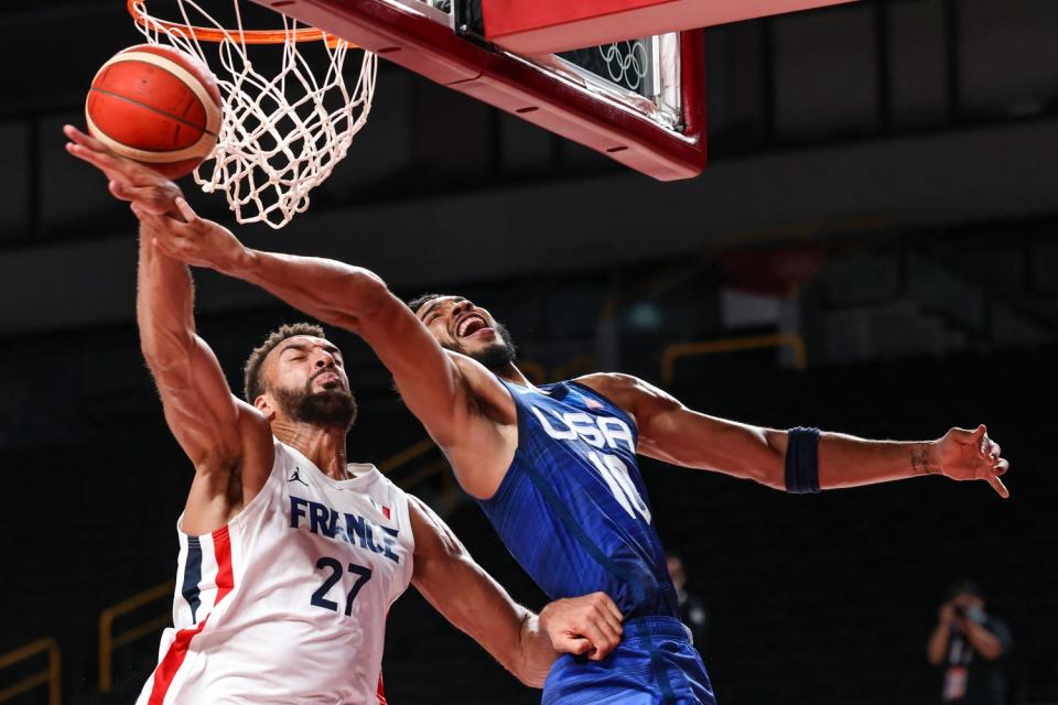 Team United States small forward Jayson Tatum (10) fouled by Team France center Rudy Gobert (27)