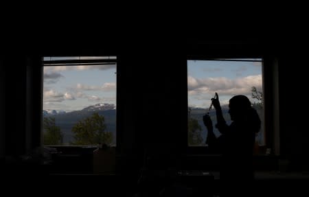 Kathryn Bennett, who studies methane at the University of New Hampshire, works in a laboratory at a research station in Abisko