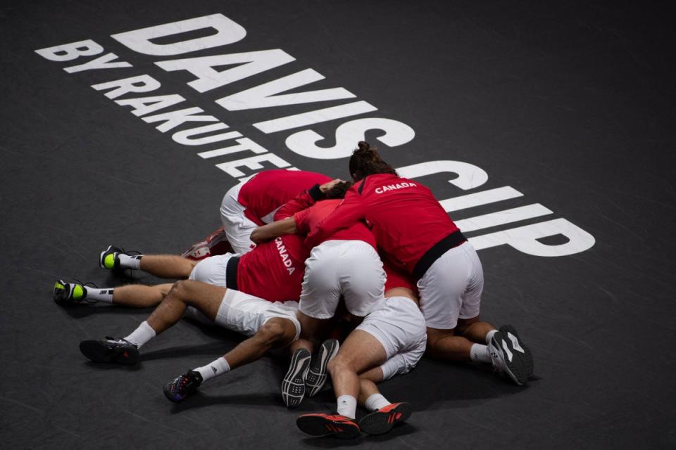 27 November 2022: Canada’s Felix Auger-Aliassime celebrates with teammates after winning his men’s single match in the Davis Cup final. Auger-Aliassime sealed tennis history for Canada as they won their first Davis Cup title by beating Australia 2-0 (AFP/Getty)