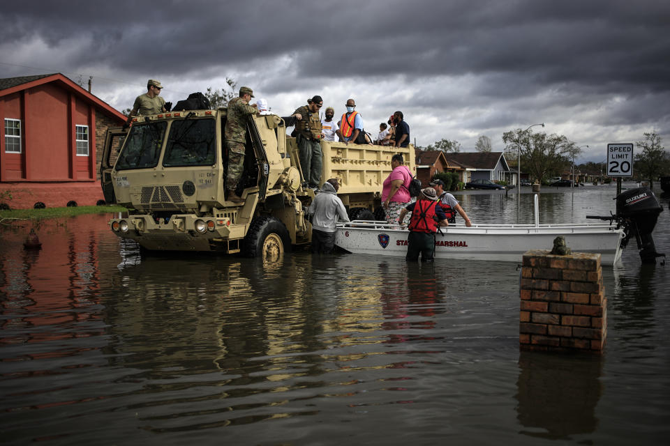 First responders drive a high water vehicle through flooded streets while rescuing residents from floodwater left behind by Hurricane Ida in LaPlace, La., on Aug. 30, 2021. (Luke Sharrett / Bloomberg via Getty Images)