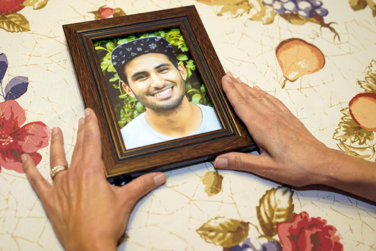 Dolores Cruz shows a photograph of her youngest son, Eric Cruz, on Wednesday, Feb. 1, 2023, at her home in San Gabriel, Calif. Cruz published an essay in 2022 about grieving for her son, who died in a car crash in 2017. "Died Suddenly" used a screenshot of the headline in the film, portraying his death as vaccine related. (AP Photo/Marcio Jose Sanchez)