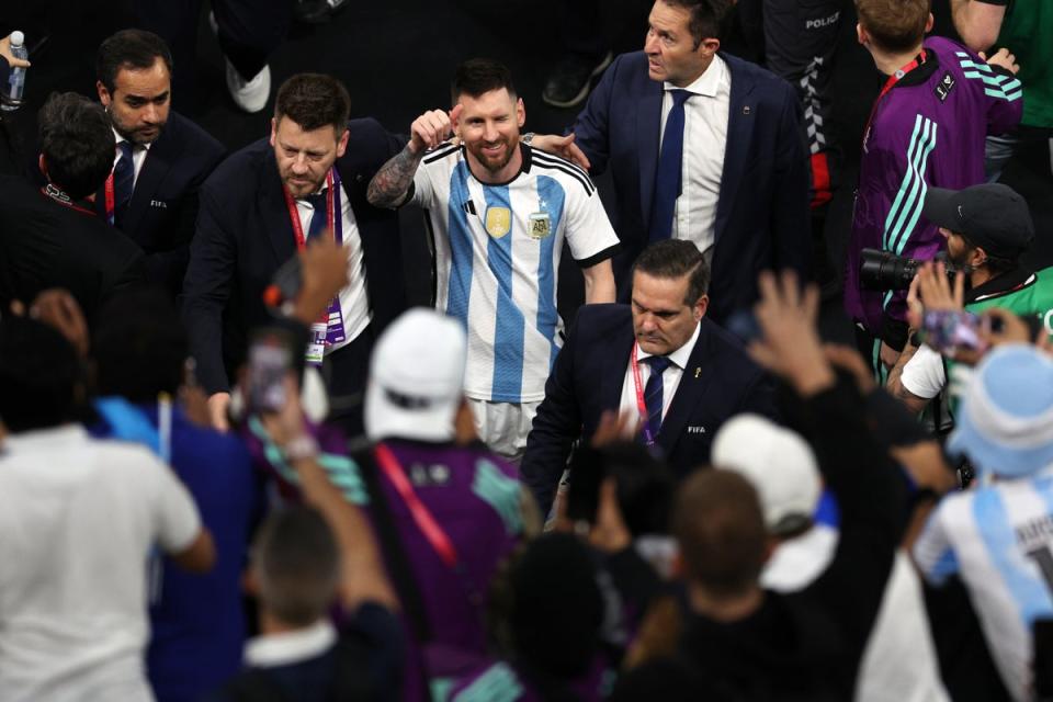 Messi walks off the pitch with protection after World Cup win (Getty)