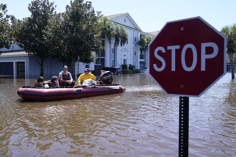 University of Central Florida students evacuate after an apartment complex near the campus, which experienced heavy flooding, on Sept. 30, 2022. / Credit: John Raoux / AP