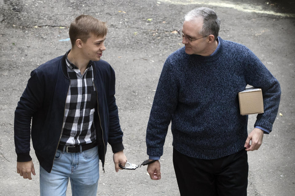 Paul Whelan, a former U.S. Marine, right, who was arrested in Moscow at the end of last year, is escorted for a hearing in a court in Moscow, Russia, Friday, May 24, 2019. The American was detained at the end of December for alleged spying. (AP Photo/Pavel Golovkin)