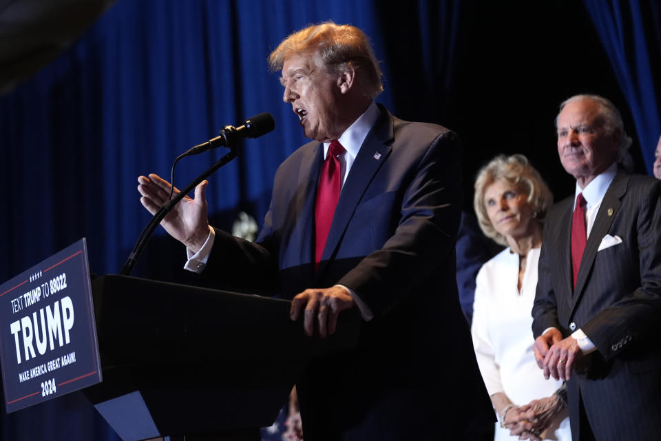 Republican presidential candidate former President Donald Trump speaks at a primary election night party at the South Carolina State Fairgrounds in Columbia, S.C., Saturday, Feb. 24, 2024., as South Carolina Gov. Henry McMaster and his wife Peggy listen. (AP Photo/Andrew Harnik)