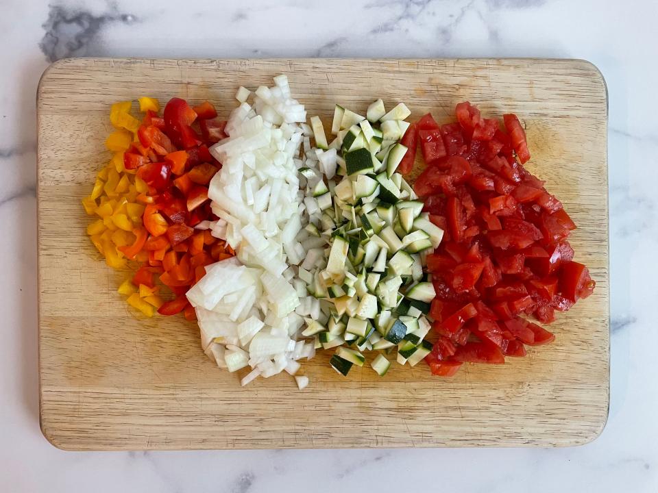 Chopped vegetables on a wooden cutting board.