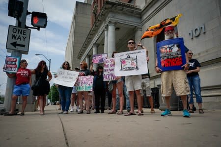 A small group of protesters gather at city hall in opposition to U.S. President Donald Trump visit to Dayton following a mass shooting in Dayton