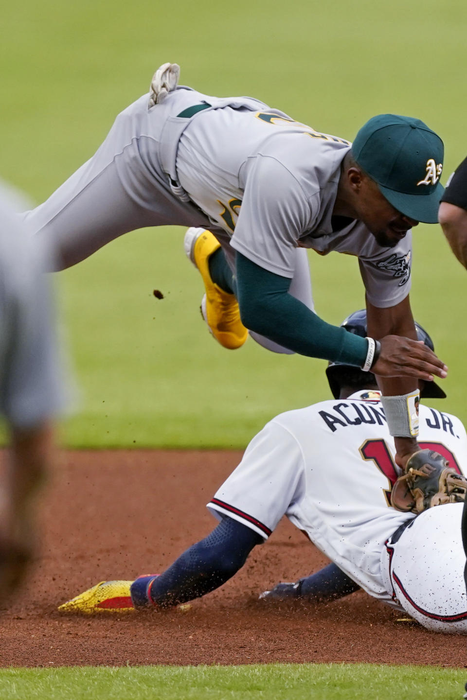 Atlanta Braves' Ronald Acuna Jr. (13) is tagged out by Oakland Athletics second baseman Tony Kemp (5) as he tried to steal second base during the first inning of a baseball game Wednesday, June 8, 2022, in Atlanta. (AP Photo/John Bazemore)